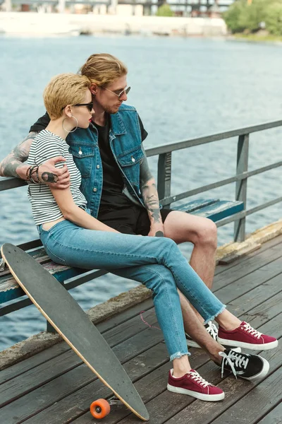 Stylish Couple Sitting Bench Bridge Looking Away — Stock Photo, Image