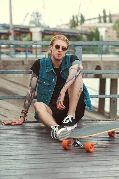 Handsome Stylish Tattooed Skater Sitting Bridge Longboard — Stock Photo, Image