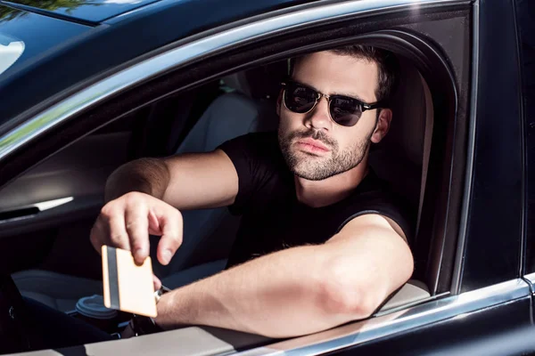 Serious Young Man Sunglasses Giving Credit Card While Sitting His — Stock Photo, Image