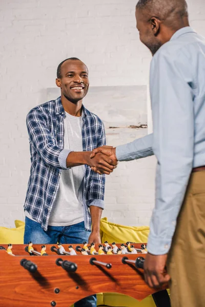 Senior Father Adult Son Shaking Hands While Playing Table Football — Stock Photo, Image