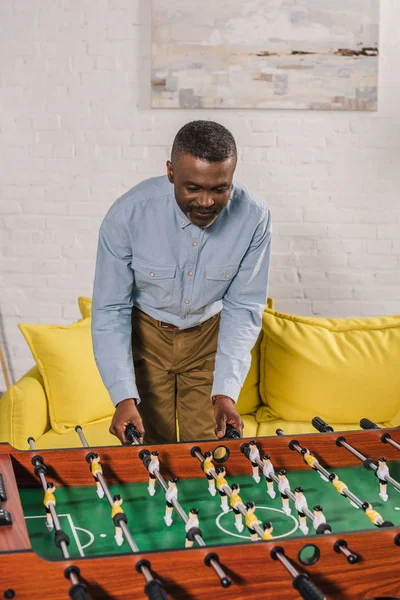 Smiling African American Man Playing Table Football Home — Free Stock Photo