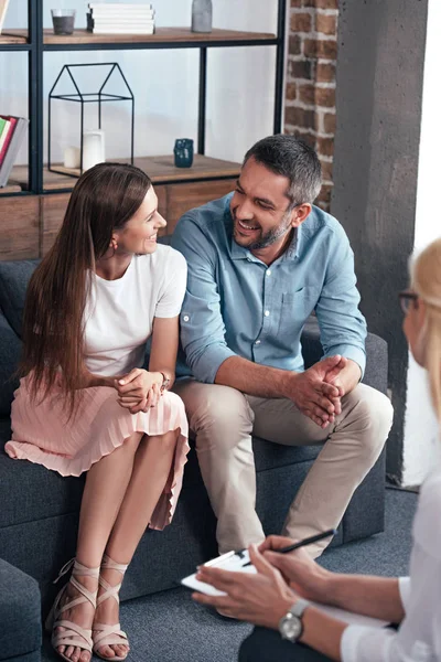 Smiling Couple Looking Each Other Sitting Therapy Session Female Counselor — Stock Photo, Image