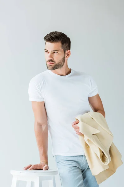 Handsome Bearded Man Holding His Jacket Arm Leaning Stool Isolated — Stock Photo, Image