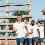 Selective focus of african american tactical instructor and interracial soldiers on range