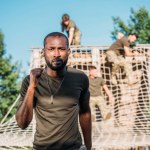 Selective focus of multiethnic soldiers practicing in obstacle run on range