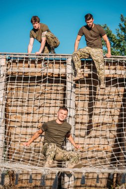 young soldiers practicing during obstacle run on range clipart