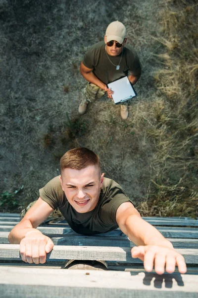 Overhead View African American Tactical Instructor Notepad Examining Young Soldier — Free Stock Photo