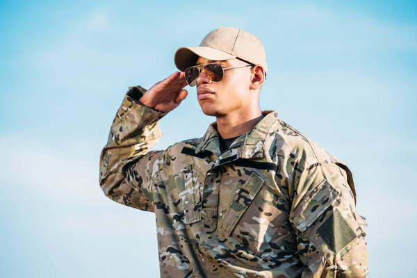 portrait of african american soldier in military uniform, cap and sunglasses
