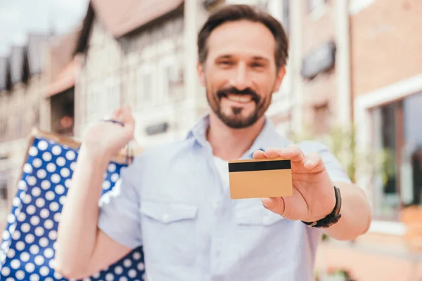 Smiling Handsome Man Showing Credit Card — Free Stock Photo