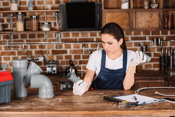 Confident Young Female Plumber Plastic Pipes Kitchen — Stock Photo, Image