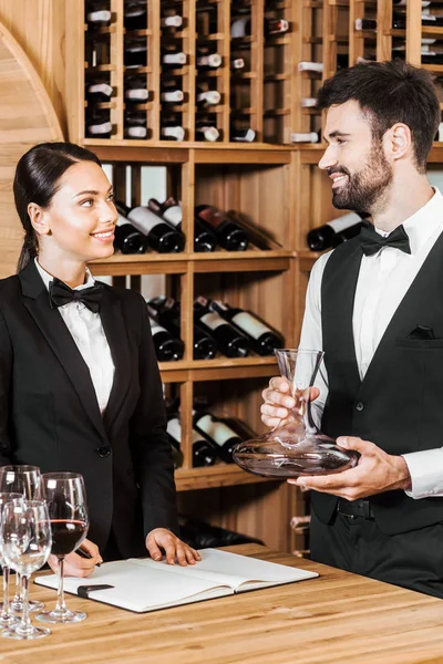 couple of wine stewards counting glassware at wine store