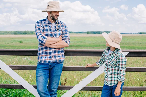 Father Son Panama Hats Looking Each Other While Standing Fence — Stock Photo, Image