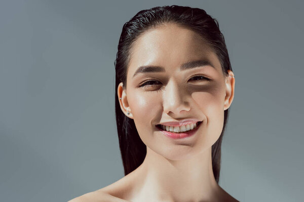 beautiful cheerful asian girl, isolated on grey