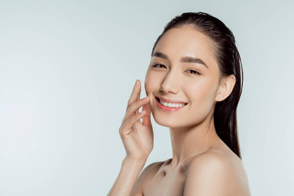 portrait of beautiful cheerful asian girl, isolated on grey