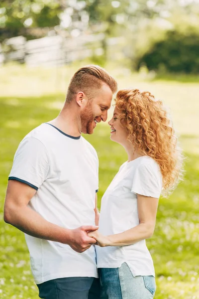 Side View Happy Young Couple Holding Hands Smiling Each Other — Stock Photo, Image