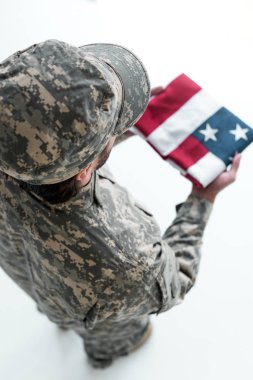 overhead view of male soldier in military uniform with american flag in hands clipart
