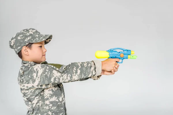 Side View Boy Camouflage Clothing Toy Water Gun Isolated Grey — Free Stock Photo