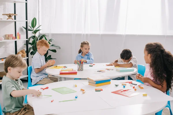 Cute Multiethnic Preschoolers Sculpturing Figures Plasticine Tables Classroom — Stock Photo, Image