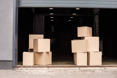 cardboard boxes on each other near open garage clipart