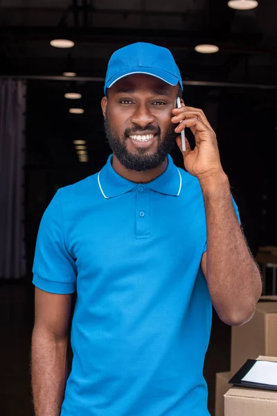 African American Delivery Man Talking Smartphone Looking Camera — Stock Photo, Image
