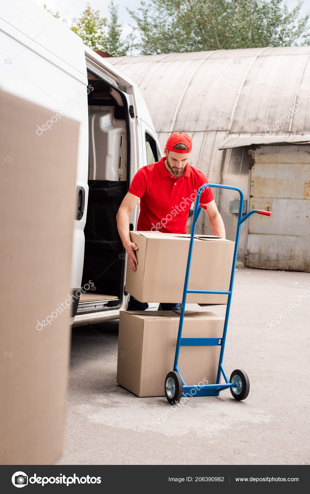Young Delivery Man Discharging Cardboard Boxes Van — Stock Photo