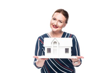 smiling female estate agent presenting maquette of house isolated on white background clipart