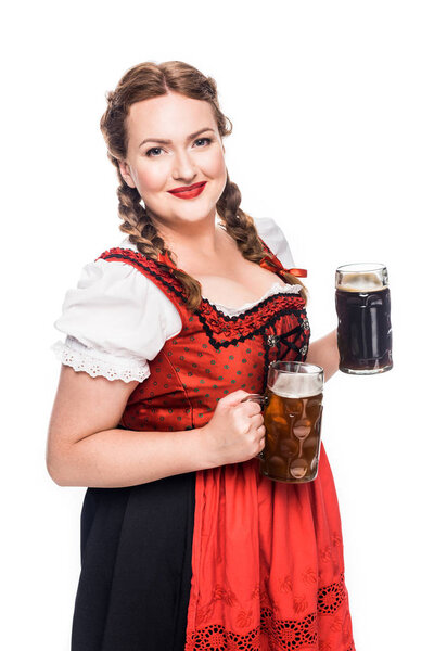 happy oktoberfest waitress in traditional bavarian dress holding mugs with light and dark beer isolated on white background
