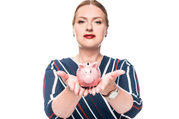 beautiful female accountant showing pink piggy bank isolated on white background 