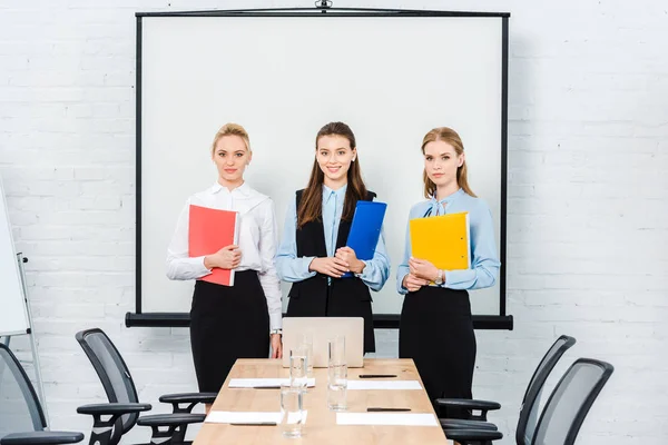 Successful Young Businesswomen Folders Documents Looking Camera Conference Hall — Free Stock Photo
