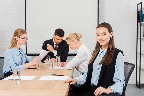Smiling Young Businesswoman Sitting Modern Office Looking Camera While Colleagues — Stock Photo, Image