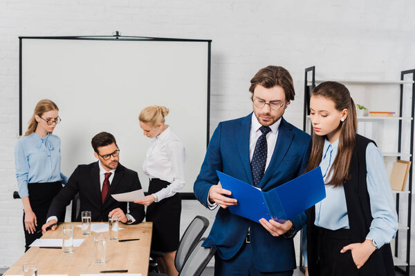 business people discussing documents together at modern office