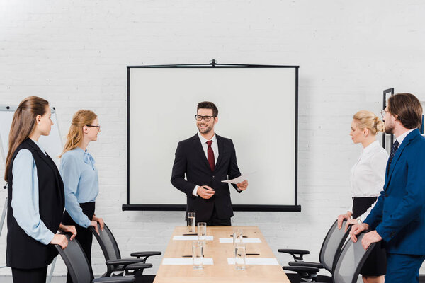 team of business people standing at conference hall before conversation