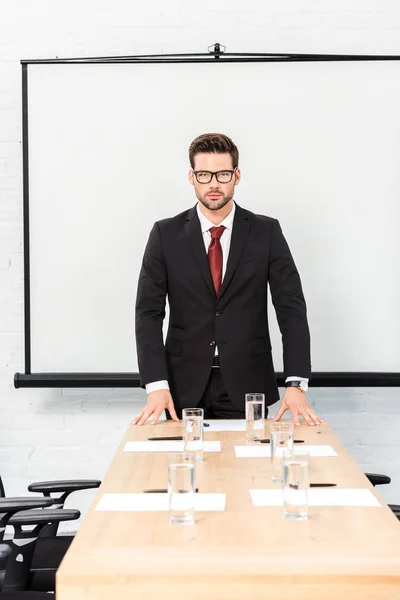 Handsome Young Businessman Looking Camera While Leaning Table Conference Hall — Stock Photo, Image