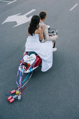 wedding couple riding scooter with 