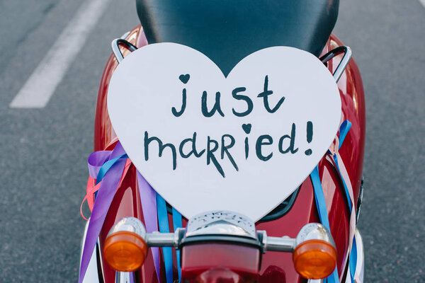 close up of scooter with "just married" heart symbol for wedding