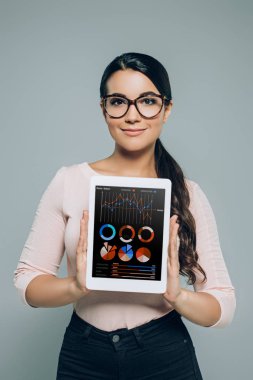 kadın gösteren dijital tablet iş çizelgeler ve grafikler, gri izole için cihaz ile