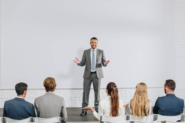 Handsome Business Coach Standing Stage Gesturing Training Hub Stock Picture