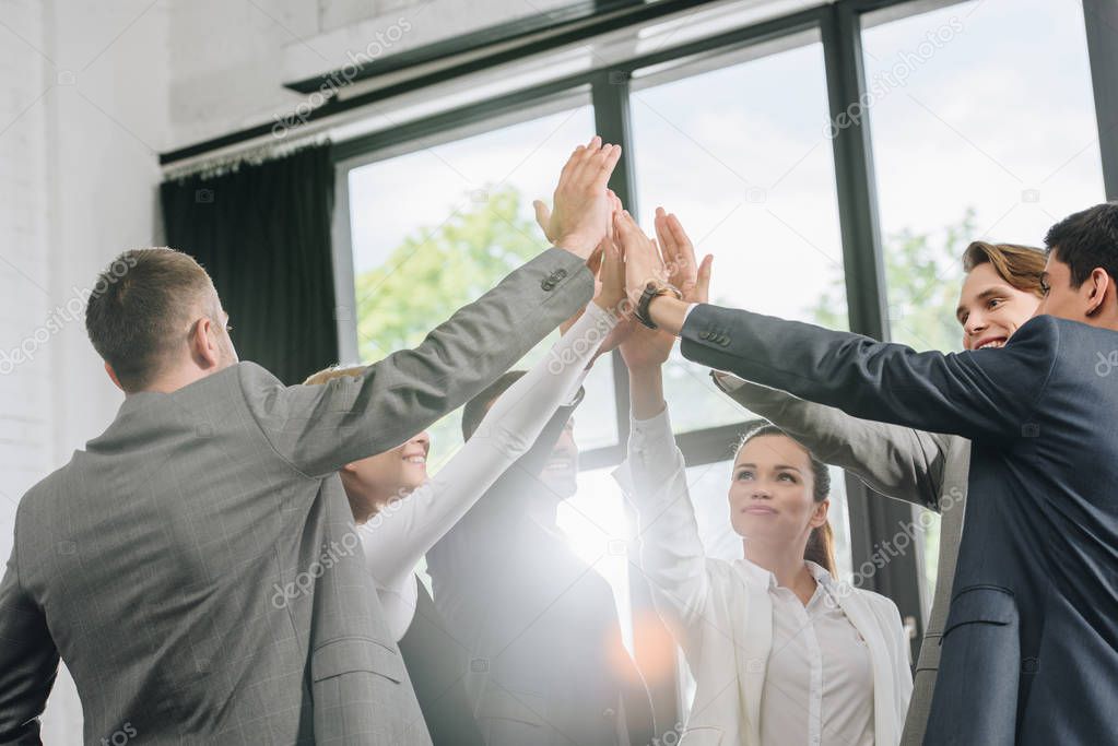 businesspeople giving high five after training in hub