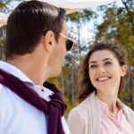 Portrait of happy woman looking at husband in sunglasses
