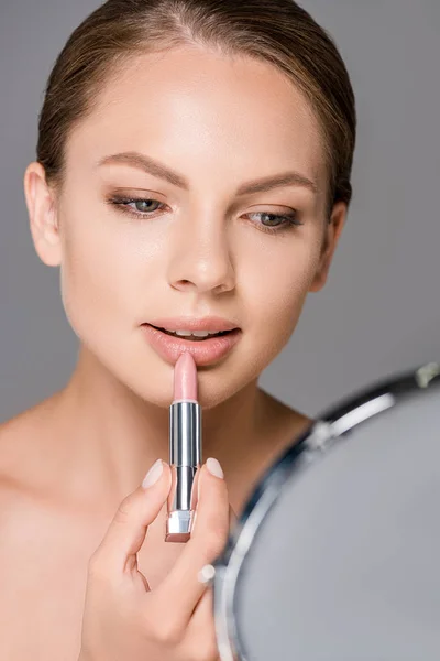 Portrait Young Woman Mirror Applying Nude Lipstick Isolated Grey — Free Stock Photo