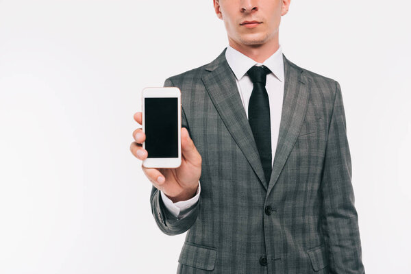 cropped image of businessman showing smartphone isolated on white