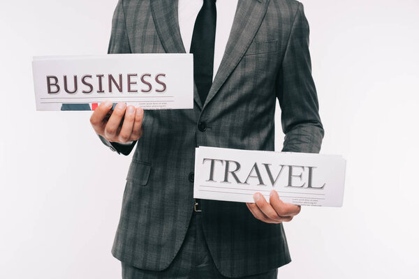 cropped image of businessman showing business and travel newspapers isolated on white