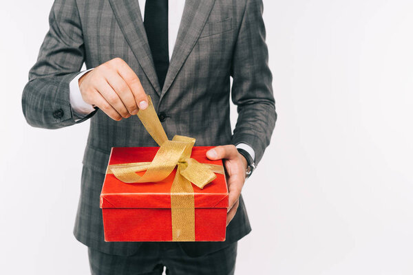cropped image of businessman opening gift box isolated on white