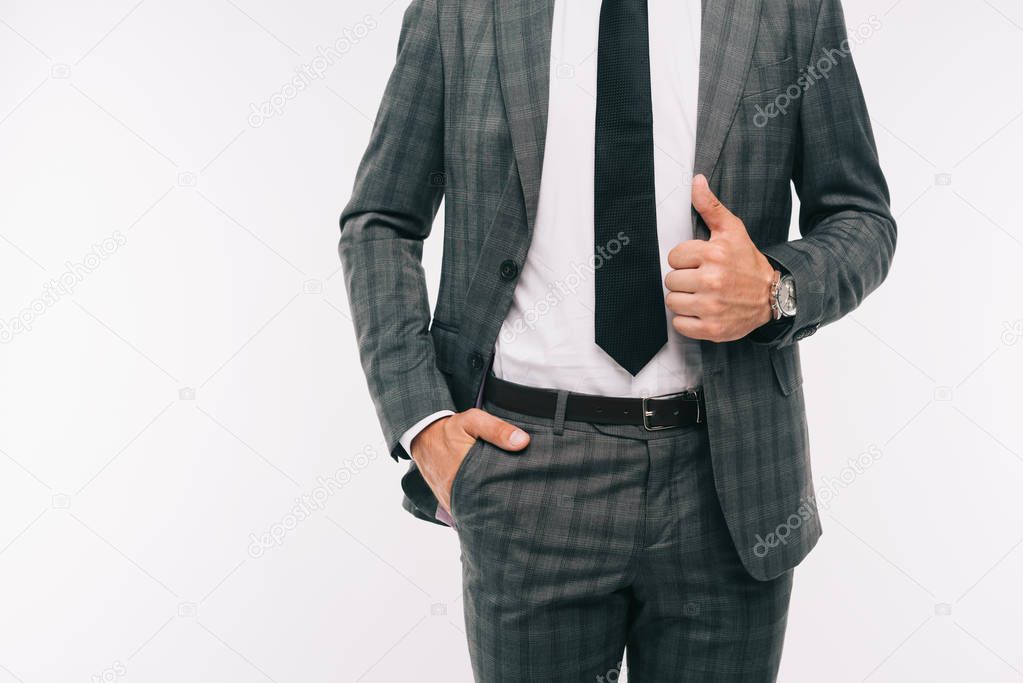 cropped image of businessman holding jacket and standing with hand in pocket isolated on white 
