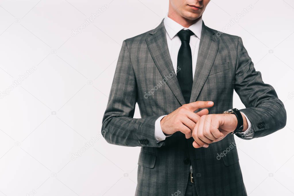 cropped image of businessman checking time at wristwatch isolated on white