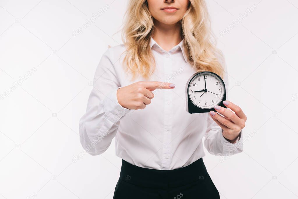 cropped image of businesswoman pointing on clock isolated on white