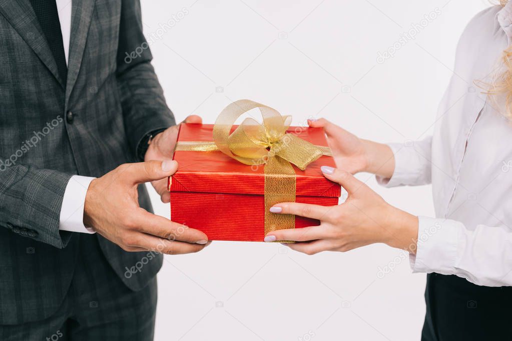 cropped image of businesswoman presenting gift to colleague isolated on white 