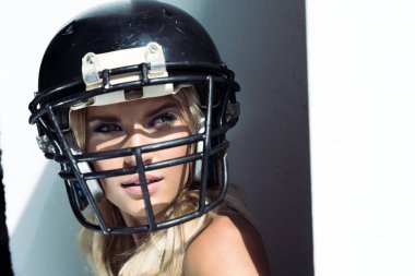 close-up portrait of young woman in sport bra and american football helmet on white clipart
