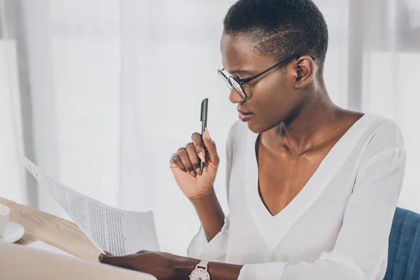 Stylowe Atrakcyjne African American Kobieta Trzymając Pióro Czytanie Dokumentów Biurze — Zdjęcie stockowe