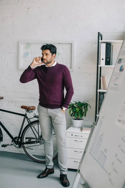 Handsome Designer Burgundy Sweater Talking Smartphone Office Looking Away — Stock Photo, Image